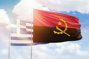 Sunny blue sky and flags of angola and greece