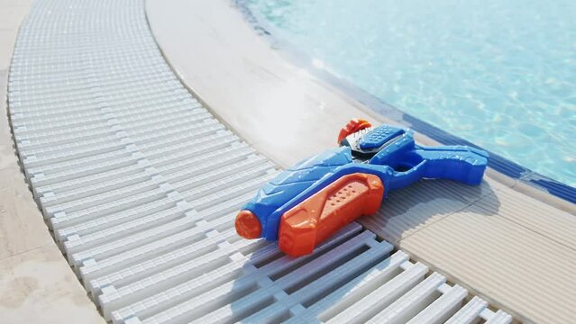 Close-up of a toy water gun in a public pool
