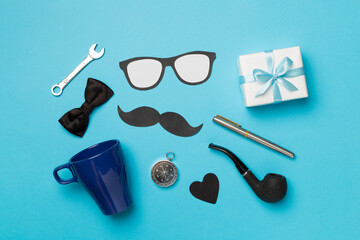 Father's Day accessories on color background, top view