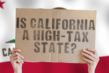 The question " Is California a high-tax state? " is on a banner in men's hands with a blurred Californian flag in the background. Cost. Budget. Crisis. Decision. Earnings. Freedom. Interest. Revenue