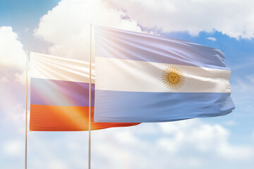 Sunny blue sky and flags of argentina and russia