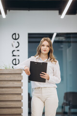 businesswoman holding a document in an office