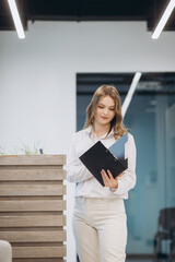 businesswoman holding a document in an office