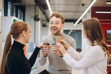 Businessman serving coffee to colleagues in office