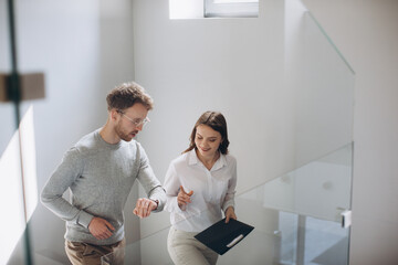 Two colleagues chat on the stairs