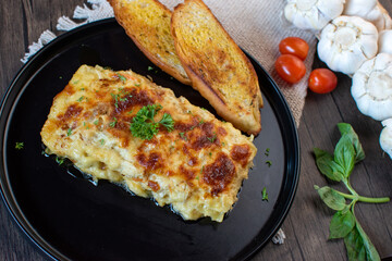 Delicious chicken lasagna with bread and oil