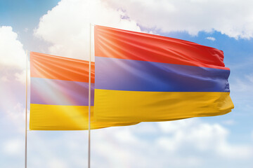Sunny blue sky and flags of armenia and armenia
