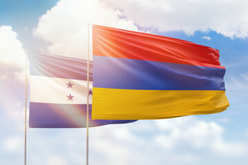 Sunny blue sky and flags of armenia and honduras