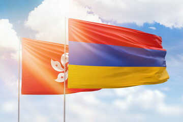 Sunny blue sky and flags of armenia and hong kong