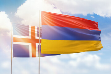 Sunny blue sky and flags of armenia and iceland