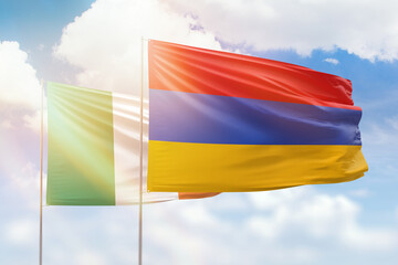 Sunny blue sky and flags of armenia and ireland