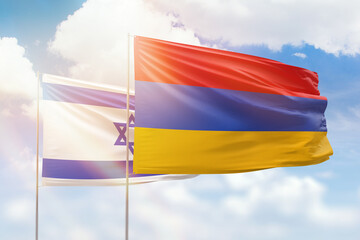Sunny blue sky and flags of armenia and israel