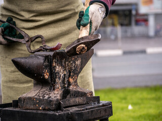 Detail shot of metal being worked at a blacksmith forge