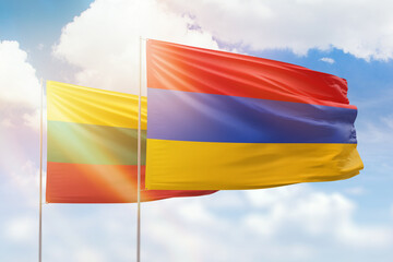 Sunny blue sky and flags of armenia and lithuania