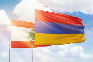 Sunny blue sky and flags of armenia and lebanon