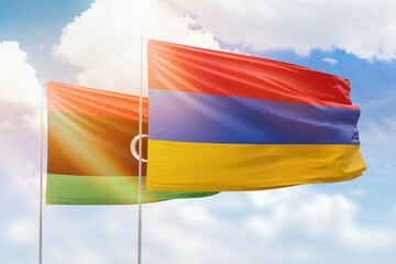Sunny blue sky and flags of armenia and libya