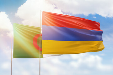 Sunny blue sky and flags of armenia and algeria