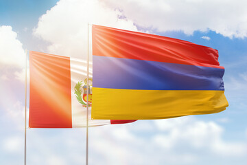 Sunny blue sky and flags of armenia and peru