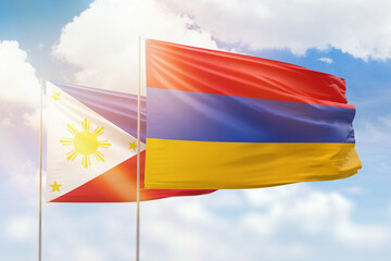 Sunny blue sky and flags of armenia and philippines