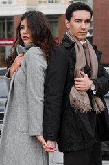 a beautiful young couple walking around the city.man and woman in business style