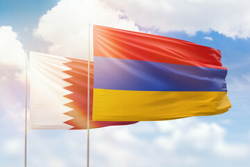 Sunny blue sky and flags of armenia and qatar