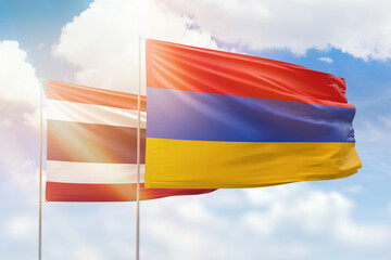 Sunny blue sky and flags of armenia and thailand