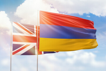 Sunny blue sky and flags of armenia and united kingdom