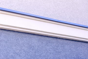 foam plastic border on the plastered and painted facade of the building