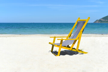 Wooden deck chair on white sand against south china sea in Nha Trang Vietnam