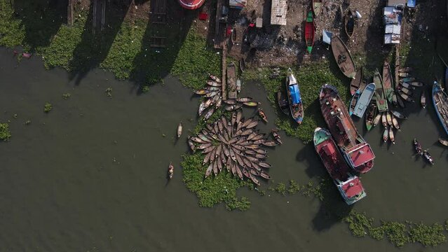 Boat wharf with shipyard at the shore of sea coast. Aerial circling shot