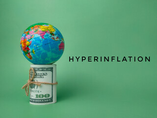 Earth globe and banknotes with the word HYPERINFLATION on a green background.