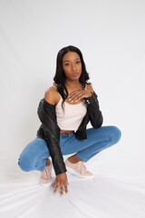 Beautiful woman looking thoughtful in a squat