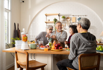 Group of Asian elder people friends making vegetables salad and fruit juice with her daughter in kitchen at home.concept of Group asia senior people Healthy eating,colorful fruits and vegetables.