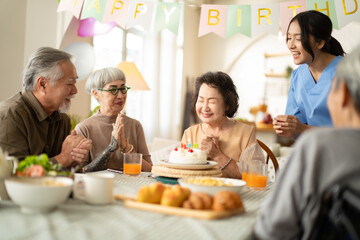 birthday party at senior in Adult Daycare Center concept.Group of asian elder people friends having birthday party in the living room at nursing home,enjoy,smile,happiness in birthday friend party