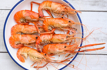 seafood plate fresh shrimp cooking on white plate background , shrimps prawns served on a food table - baked shrimp top view