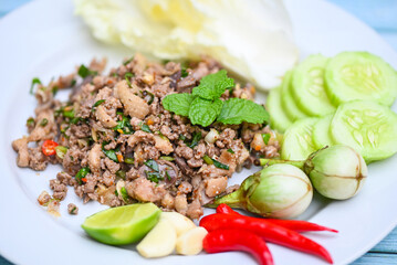 cooking duck , spicy minced duck salad with herb spices fresh vegetable eggplant cucumber chinese...