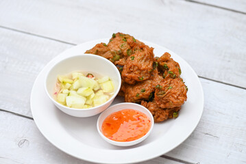 fish cakes on white plate , fried fish paste balls with sauce - Asian Thai food