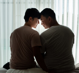 Fototapeta premium Gay couple hug and share emotion and affection together. They comfort each other while embracing.