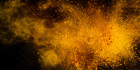 Explosion, Splashes of turmeric on a black background. India Seasoning. The orange powder of the turmeric root. Explosion of powder