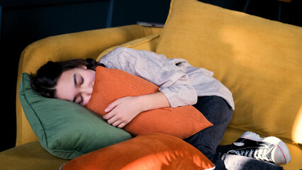 Frustrated introvert girl aged 13 lies on the couch at home and suffers from school discrimination...