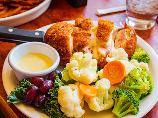 Close up shot of deep fried pork cheese steak with vegetables