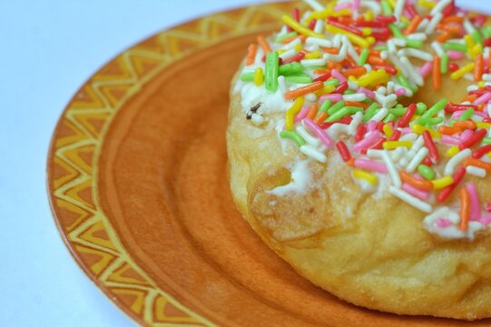 a donut sprinkled with colorful meses