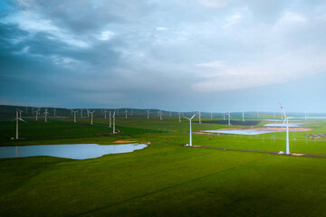 Wind turbine farm at sunset. Renewable energy concept. Producing alernative energy in windmills