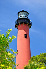 Historic red brick Jupiter lighthouse against blue skies at Jupiter Inlet, Florida © Ryan Tishken