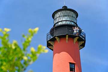 Tourists visting the top of historic Jupiter lighthouse under blue skies at Jupiter Inlet, Florida © Ryan Tishken