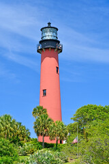 Historic red brick Jupiter lighthouse against blue skies at Jupiter Inlet, Florida © Ryan Tishken