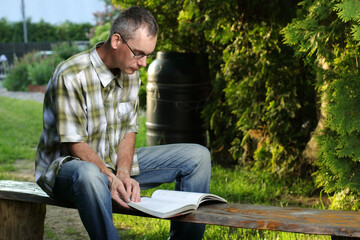 a person in a t-shirt is reading a book