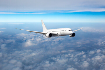 Passenger plane in flight. Aircraft fly high in the sky above the clouds. Front view of aircraft.