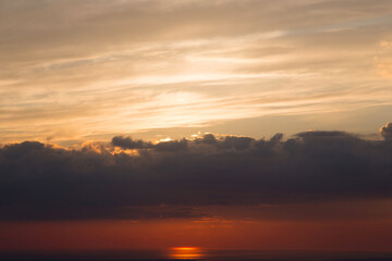 Naklejka na ściany i meble Colorful sunset cloudy sky view from airplane window