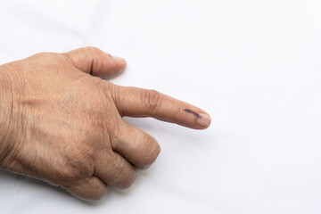 A senior citizen Indian woman voted , exercized her voting right and got her index finger inked....